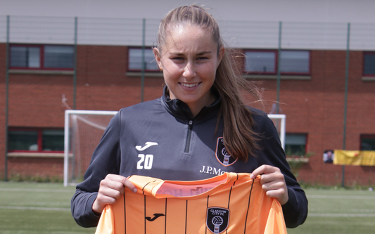 Kenzie Weir holding up a Glasgow City jersey